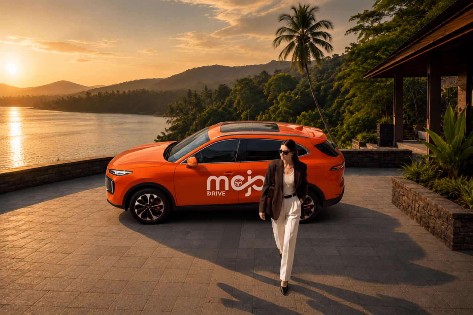 A woman walking past an orange Mojo Drive SUV at golden hour beside a palm-lined lake