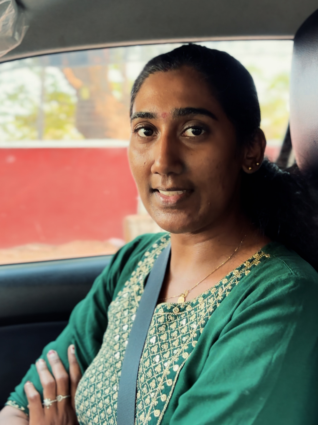 Varna seated in a car after her Mojo Drive lesson